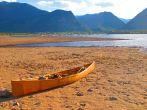 A canoe rests quietly at dusk, as the sunset casts a nice glow over Lake Dillon and the surrounding area- Frisco, CO.