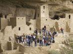 Tourists viewing kiva at Cliff Palace cliff dwelling Indian ruin, the largest in North America, Mesa Verde National Park, Southwestern Colorado.