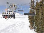 A group of young skiiers riding up the chair lift in Keystone, Colorado on winter vacation. 