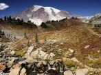 Majestic Mount Rainier blushing with valleys covered with fall colors.