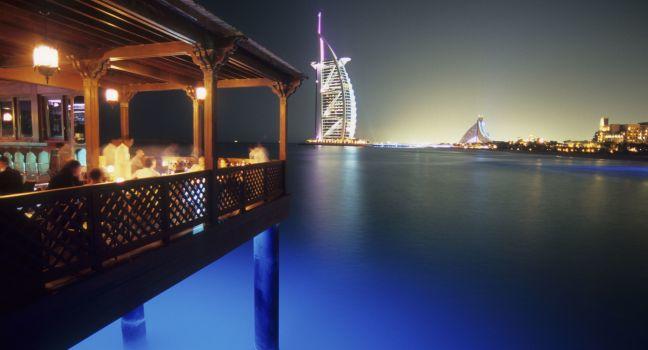 The Pierchic Restaurant seems to float above its fairytale location way out on an Arabian Gulf wharf where diners devour scallops tatare and gaze at a glowing Dubai skyline. Dubai, UNited Arab Emirates