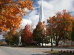 Autumnal shot of the main street of Manchester Vermont in fall as the bright trees turn orange and red