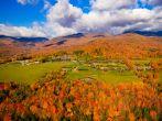 Aerial view of fall foliage including Trapp Family Lodge, Stowe, Vermont, USA