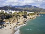 Scenic resort town of Nerja with small sandy beach on Costa del Sol by the Mediterranean Sea in Spain, southern Andalusia region, Malaga province. 