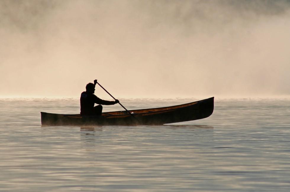 Silhoutte of a canoeist on Burnt Island Lake - Ontario, Canada.