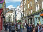 A busy and vibrant Carnaby Street in the west End of London. One of the most popular and trendiest shopping streets in London, made famous in the 1960s by the mods and the hippies.