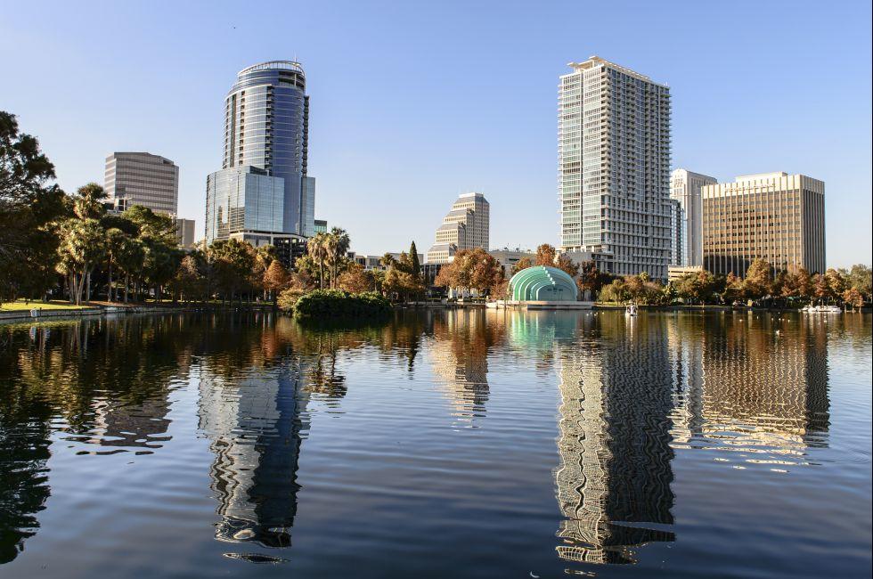 Orlando Lake Eola in the afternoon with urban skyscrapers and clear blue sky.;  