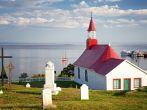 Chapel of Tadoussac, historical monument built of wood in 1747. The red-roofed Chapel overlooks the St Lawrence river. Quebec, Province, Canada.