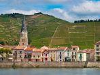 A riverside Village and Vineyards on the Hills of the Cote du Rhone Area in France.