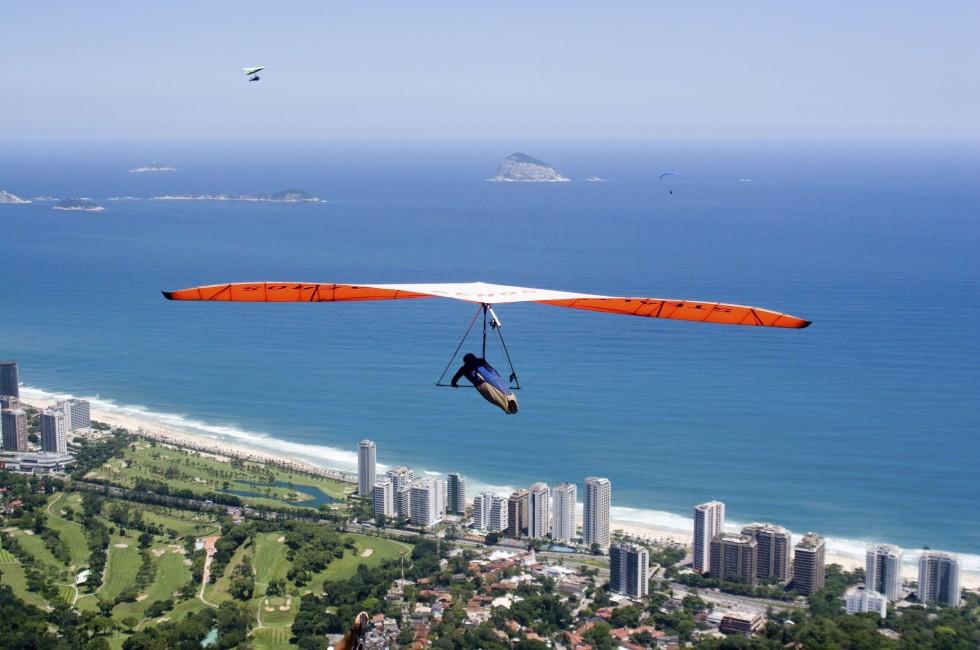 Hand glider flying over the beautidul scenery of Rio de Janeiro's coast.