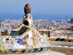 Bench in the Park Guell on July 11, 2011 in Barcelona, Spain. Famous park designed by Antoni Gaudi with a view at the city and sea. UNESCO World Heritage Site.