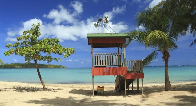 A lifeguard post stands in front of a calm aqua bay at Seven Seas Beach near Fajardo, Puerto Rico; 