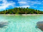 Beautiful Maldivian atoll with white beach seen from the sea.Panorama.