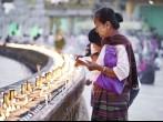 YANGON, MYANMAR - JAN 31: Buddhist devotees lighting candles at the full moon festival, Shwedagon Pagoda, January 31, 2010 in Myanmar (Burma).