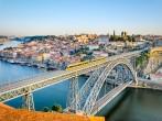 View of the historic city of Porto, Portugal with the Dom Luiz bridge. A metro train can be seen on the bridge; Shutterstock ID 148234274; Project/Title: Fodors Portugal Gold Guide; Destination: Portugal; Downloader: Jessica Parkhill