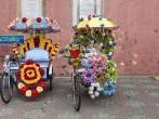 Trishaw decorated with colorful flowers in Malacca, Malaysia; 