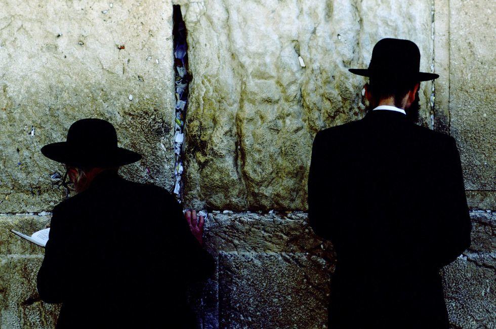 Facing eight-ton meleke limestone blocks that comprise the sacred Wailing Wall, a remnant of King David's First Temple, Chasidic Jews recite Amidah at heaven's gate.