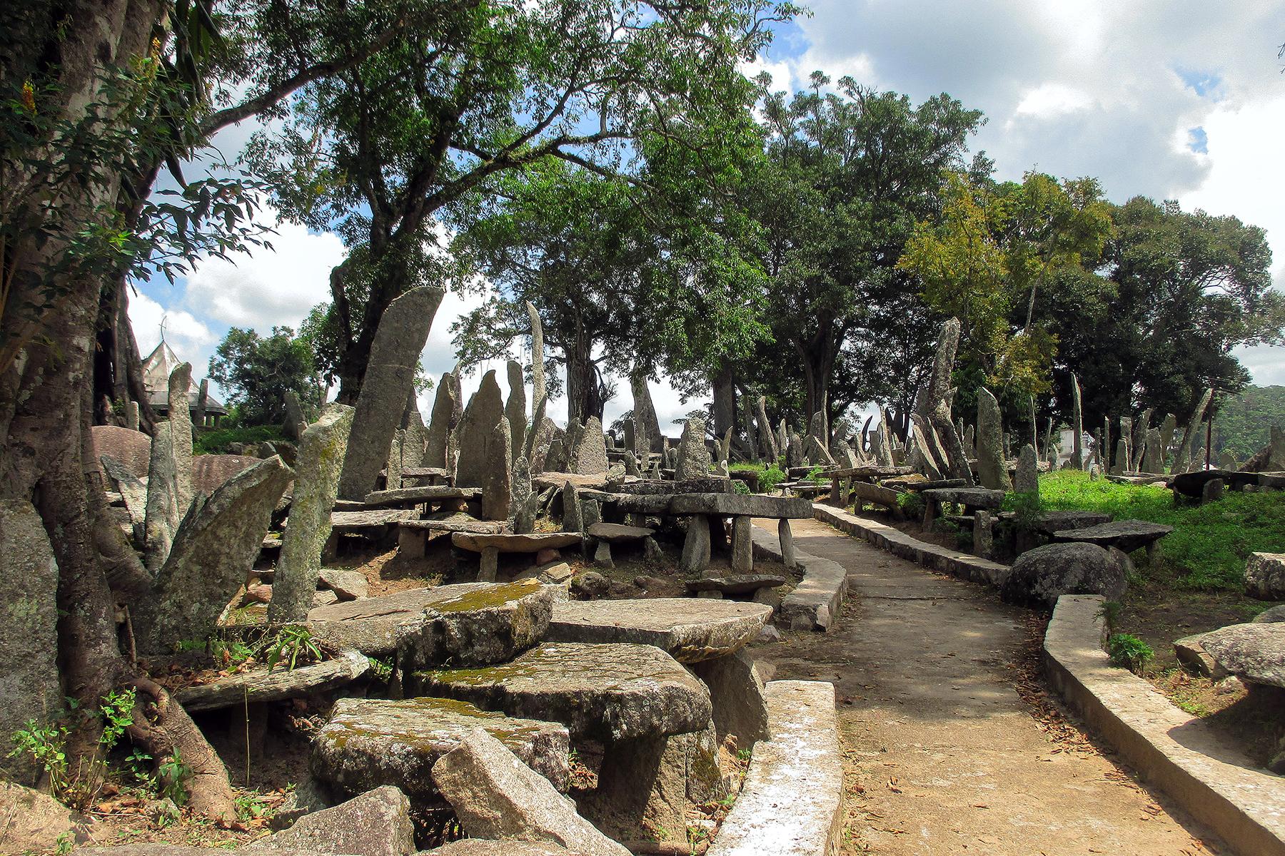 06_IndiaAdventuresInMeghalaya__ExploringTheWorldsTallestMonolithsInNartiang_6 - Monolith_memorials_under_shady_trees