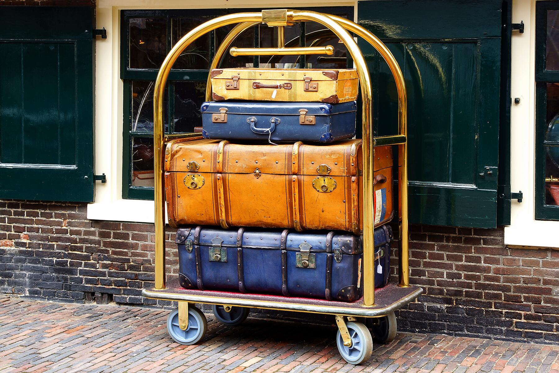 Visitors take photos of a suitcase on display during the Louis