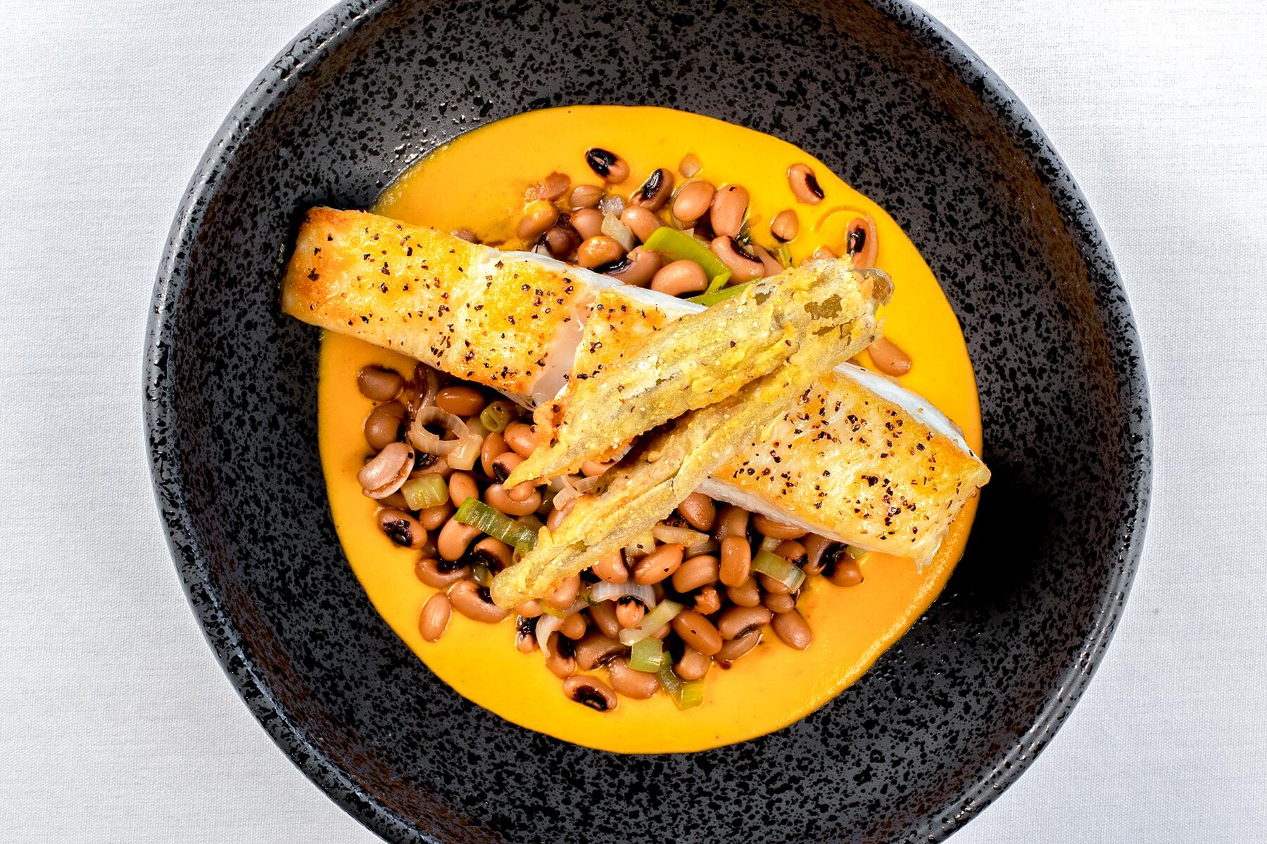 2-Market Steer Pan Roasted Halibut with Southern-style black eyed peas, habanero corn reduction and fried okra credit Justin Goode