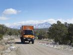 WILD RIVERS RECREATIONAL AREA, NEW MEXICO, USA - April 15: Custom orange RV truck driving on snowy dirt road on April 15, 2014 at Wild Rivers Recreational Area, New Mexico, USA.  