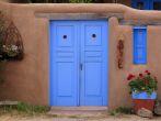 Adobe building and blue door in Rancho de Taos, NM